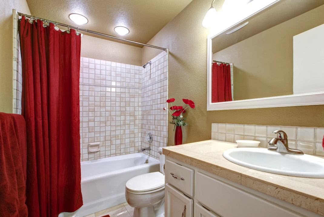 Bathroom With a Red Shower Curtain 
